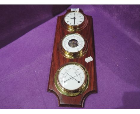 A vintage wall mounted clock and barometer set