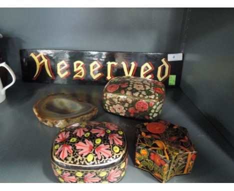 A selection of hand decorated papier mache trinket boxes and reserved sign