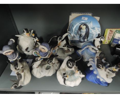A selection of ceramic figures by the Franklin mint all penguin themed