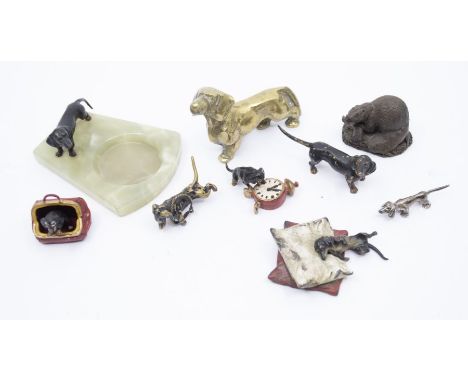 A group of cold painted alloy vintage models of dachshunds to include: one sleeping on two cushions; 925 silver example; onyx