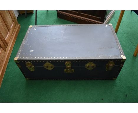 An early 20th Century travel trunk, blue ground, with metal fittings and studs, appears to be locked, no key