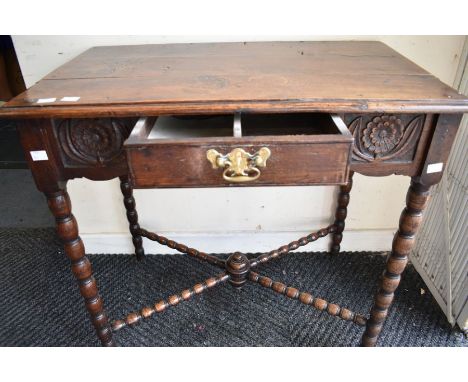 A late 17th century oak lowboy hall table with bobbin-turned legs and x-stretcher, peg joints and a panel top. It has a singl