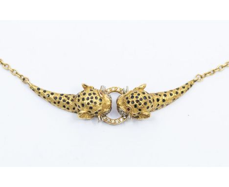 A Cartier style  ruby and diamond set 18ct gold necklace in the form of a leopard, comprising dual leopard heads with enamel 