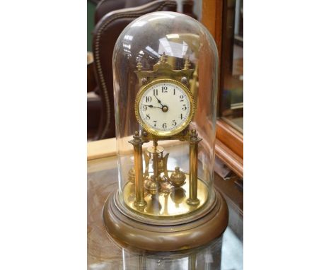 Early 20th century anniversary mantel clock with brass base and glass dome cover