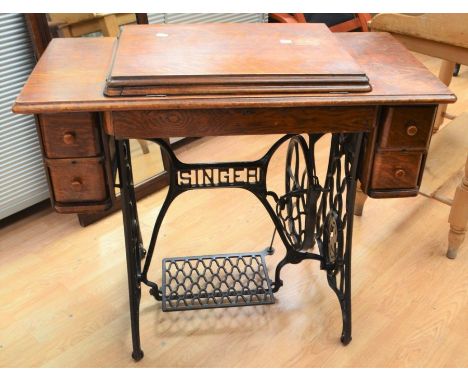 Early 20th century Singer sewing machine worktable on cast-iron frame with two single bobbin-drawers on either side