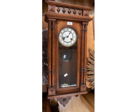 A Vienna style wall clock with 8 day sprung driven movement striking on a gong. 5" white dial. contained in a walnut style ca