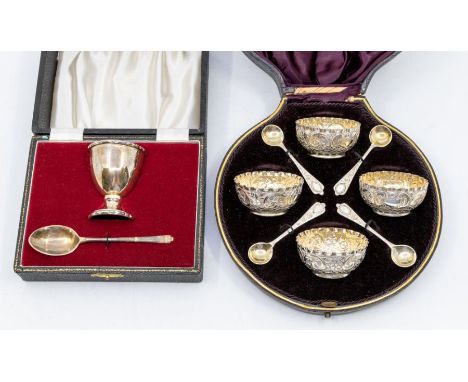 A set of four late Victorian parcel-gilt &amp; silver salts with a matched set of four spoons, shaped circular chased with sc