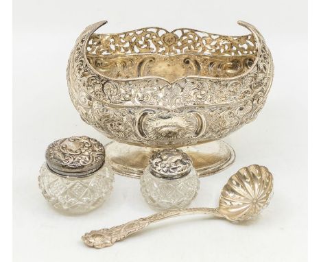 An Edwardian boat shaped silver sugar basin, reticulated border above body chased with floral and foliate scrolls, central ca