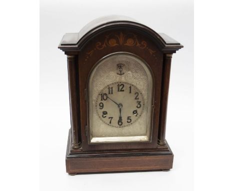 Early 20th century 8 day chiming mahogany mantle clock with inlay detail silvered face Arabic numeral.
