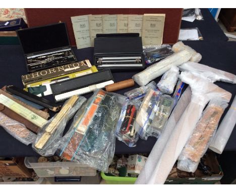 A collection of mid to late draughtsman's and other precise small tools, along with measuring rulers and set squares