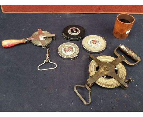 A collection of mid 20th century measuring tapes and tools