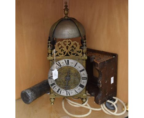 A lantern clock inscribed James Greene of Althorpe. A 30 hour rope driven verge movement striking on a bell. Contained in a b