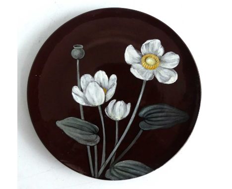 A Mintons Art Pottery Studio Kensington Gore early Art Nouveau influenced circular wall plate, the glazed background heighten