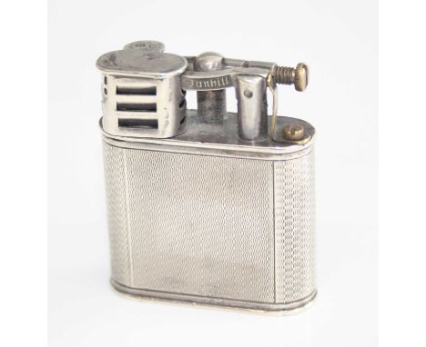 A late Art Deco silver pocket lighter by Dunhill, having engine turned exterior, hinged cap, refillable, London 1946, patent 