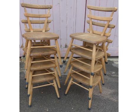 A set of eight 1960s Ercol child's blond elm yellow dot stacking chairs, each with twin bar backs, w.33cm