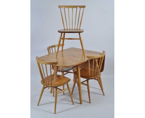 A 1960s Ercol blond elm breakfast suite comprising; drop flap table having pull-out supports on tapering legs, h.72cm, max le