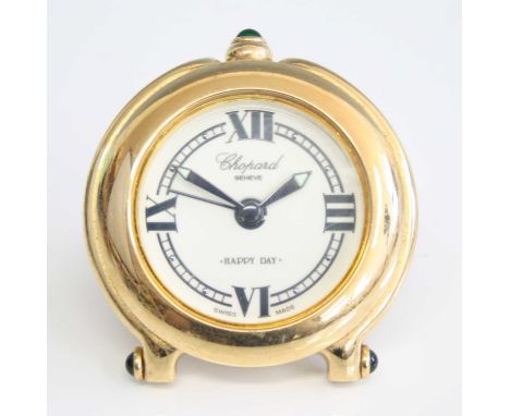A Chopard 'Happy Day' gilt brass travel alarm clock, having easel back, green glass cabochon mounts, titled to dial and backp