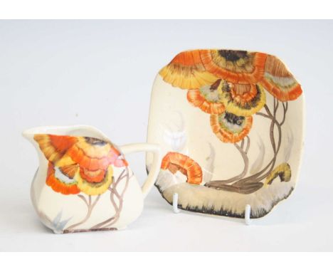 An Art Deco Clarice Cliff Rhodanthe pattern ceramic milk jug, printed marks to the underside, h.7cm, together with a matching