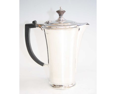 An Art Deco silver coffee pot, of cylindrical slightly waisted form, with ebonised stylised handle and finialled cover, maker