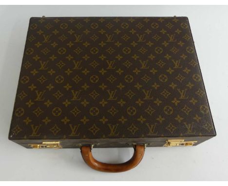 A Louis Vuitton leather briefcase, having typical repeating monogram, gilt brass hardware, tan leather handle, further tan le