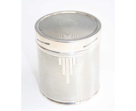 An early Art Deco silver cylindrical tobacco jar and cover, having stylised and engine turned exterior, gilt-wash interior, m