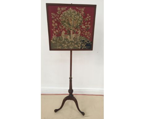 A 19th century pole screen with embroidered panel