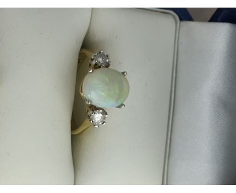 An 18ct diamond and opal dress ring