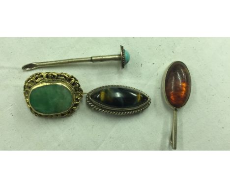 A 19th century jade pendant; together with a snuff spoon with turquoise top, tiger's eye brooch, and Danish amber pendant