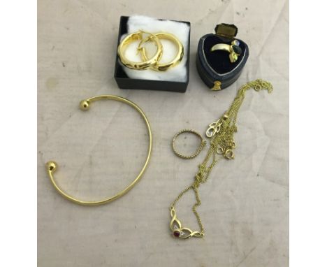 A quantity of gold items: ring, torque bangle, earrings etc