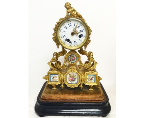 A 19th Century French Mantel Clock:Well balanced ormolu clock with putti lying on the top, with brocade of flowers around the