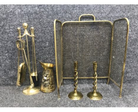 Brass 3 way folding screen together with a pair of brass open barley twist candlesticks brass jug and brass effect fire compa