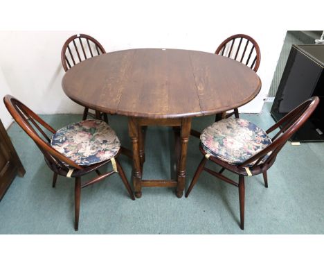 A 20th century oak drop leaf dining table and four Ercol elm and beech rail back dining chairs (5) Condition Report:Available