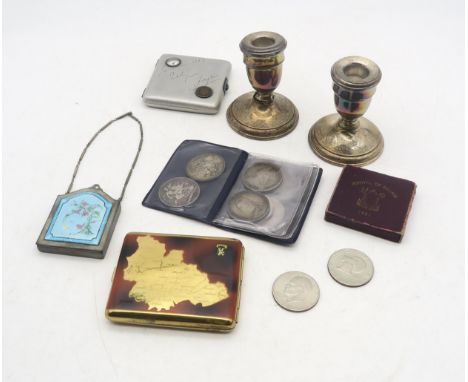 A pair of hallmarked silver dwarf candlesticks with weighted bases (makers mark "JE", London, 1923), one with damaged stem; p