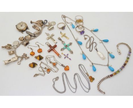 A collection of silver and gemstone crosses, a silver charm bracelet with fifteen silver and white metal charms including the