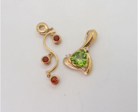 A 9ct gold peridot and diamond pendant, together with a red gem set pendant , weight together 5.4gms Condition Report:Availab