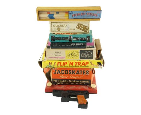 A group of vintage toys and games, including dominoes, Magic Etch A Sketch, Pick-Up Sticks, a pair of Jacoskates, etc