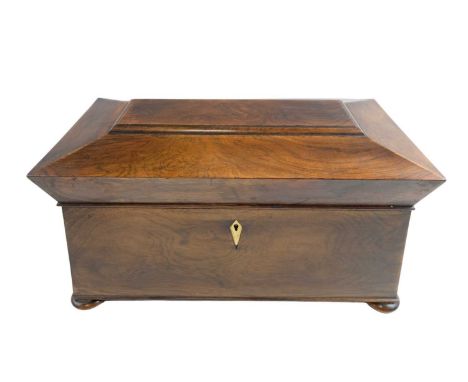A Regency sarcophagus form rosewood tea caddy, the interior having a pair of removable tea canisters and heavy cut-glass mixi