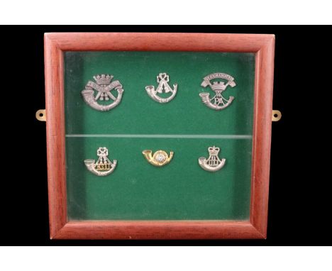 A framed display of Light Infantry badges