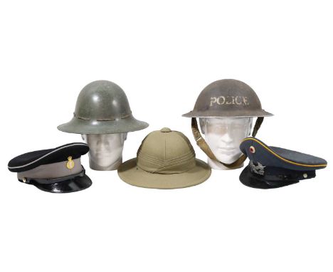 Sundry items of military headgear including a Second World War Police helmet shell, a Fire Watcher's helmet, Army Catering Co