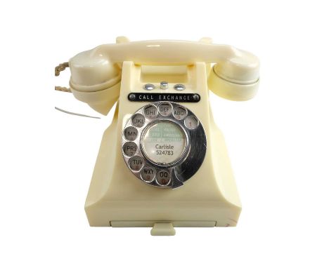 A 1950s / 1960s 300 series ivory rotary dial telephone, marked '314 FTC.54/2A', having a single button top, number drawer and