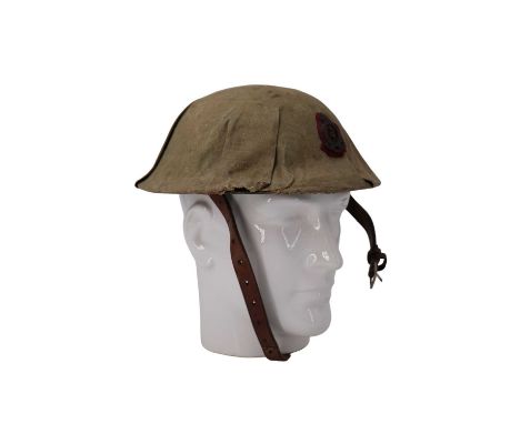 A toy British army "Brodie" steel helmet having a canvas cover and Royal Army Medical Corps badge affixed, 25 cm x 24 cm