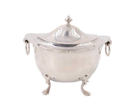 An Edwardian silver tea caddy, of oblate section having an everted rim raised on four feet with a hinged lid and loop handles