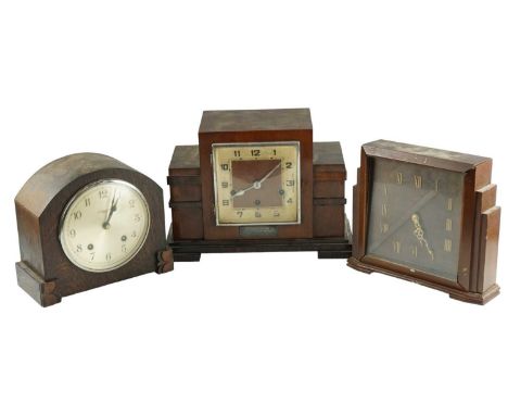 An Art Deco walnut mantle clock, striking and chiming on gongs, the case having stepped sides with rosewood bands, bearing de