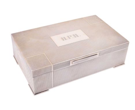 A 1940s Art Deco style silver cigarette box, decorated overall with fine engine turning, two opposed corners accentuated, the