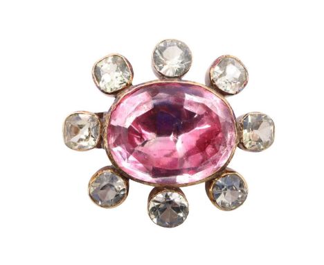 A Victorian chrysoberyl brooch, comprising a 15 x 19 mm foil-backed oval pink stone in a closed back bezel setting, surrounde