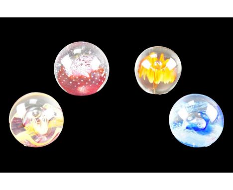 Three Caithness paperweights together with one other weight, tallest 7 cm