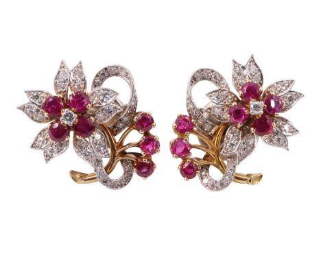 A pair of ruby and diamond floral earrings, each having a flowerhead of four 3 mm rubies centred by a 2 mm brilliant cut diam