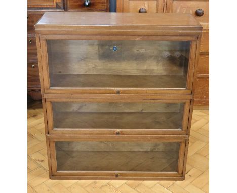 A mid 20th Century walnut Globe-Wernicke three section lawyer's bookcase, 86 x 29 x 100 cm