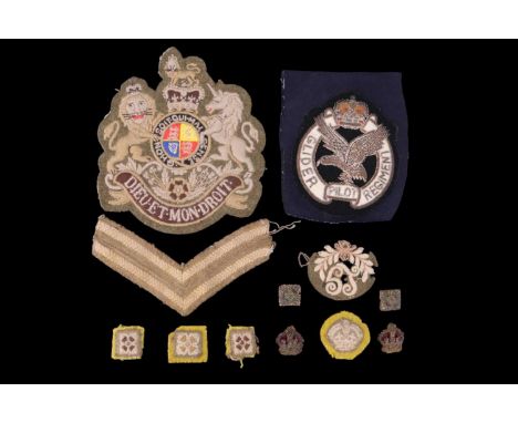 A small group of British army cloth insignia including a post-1952 RQMS rank badge and a Glider Pilot regiment blazer badge
