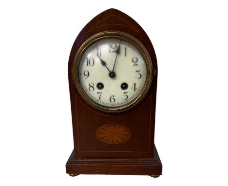 An Edwardian mahogany lancet top mantle clock, having a brass drum movement, the case decorated with an inlaid patera, 19 cm 